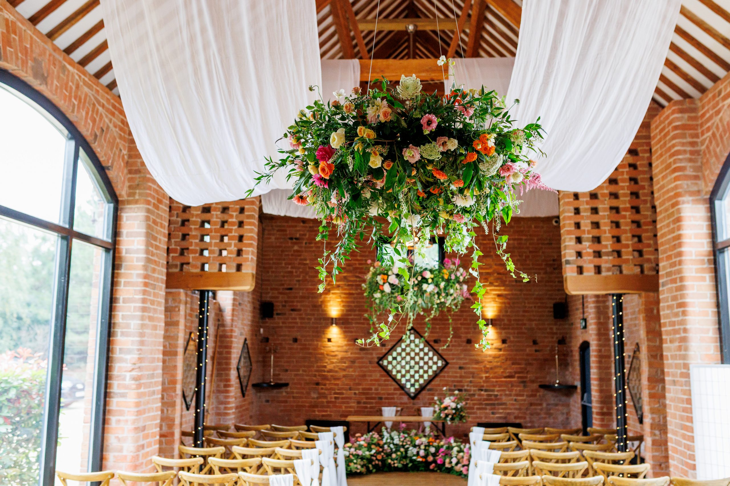 sailcloth ceiling draping and fresh flower chandeliers
