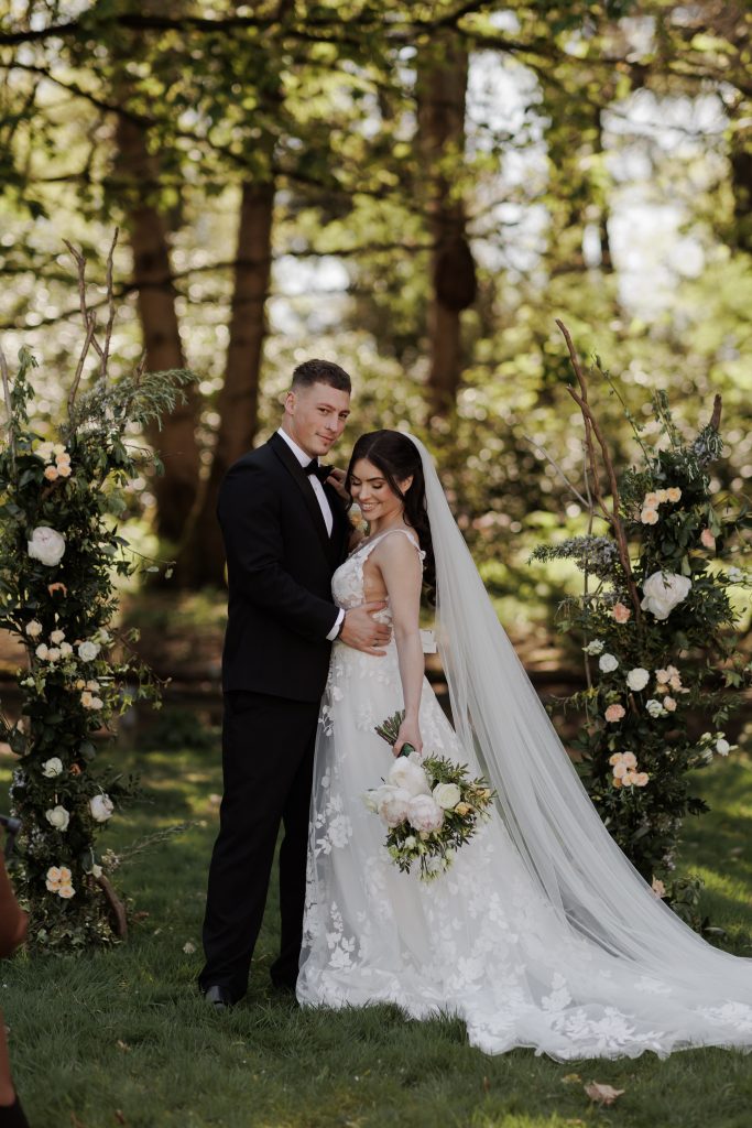 Outside wedding with split arch bride and groom