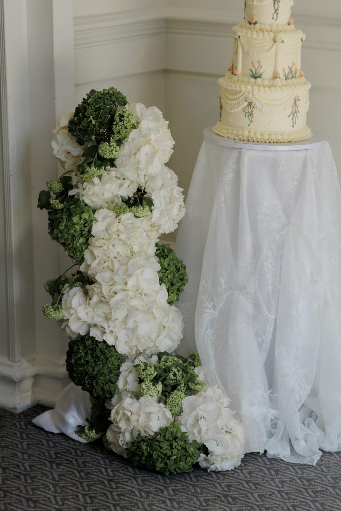 wedding cake surrounded by hydrangea waterfall