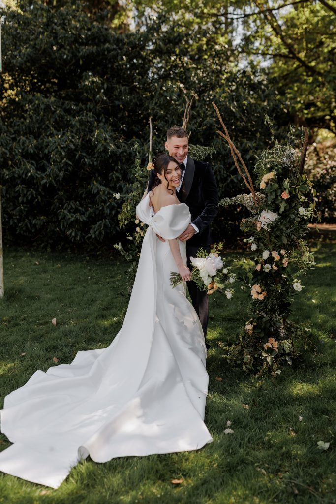 bride and groom with fresh flower bouquet