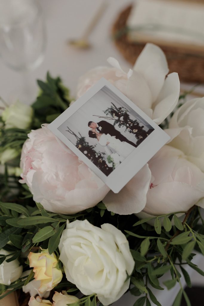 polaroid of bride and groom on brides bouquet