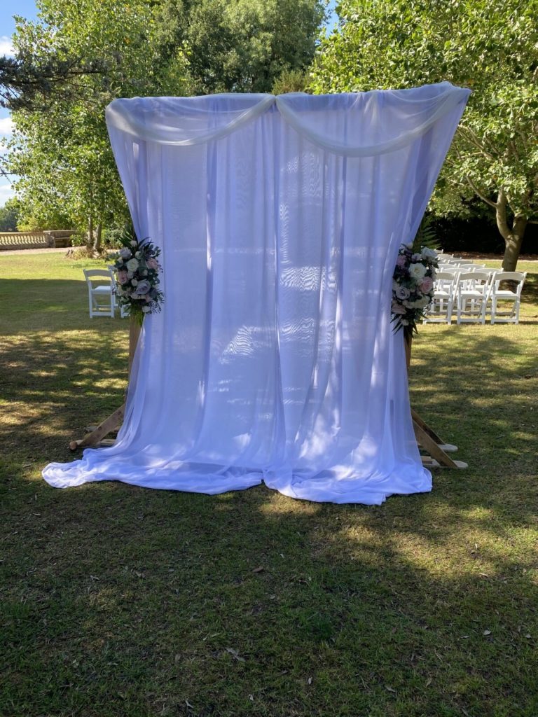 arch with drapes and flowers