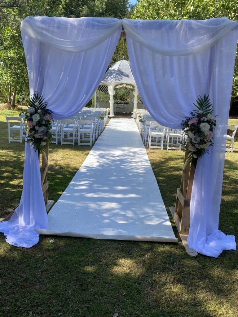 arch with drapes and flowers