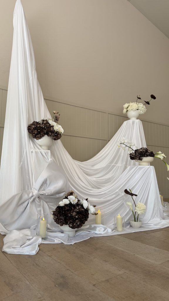 Drapery backdrop with fresh flower installation