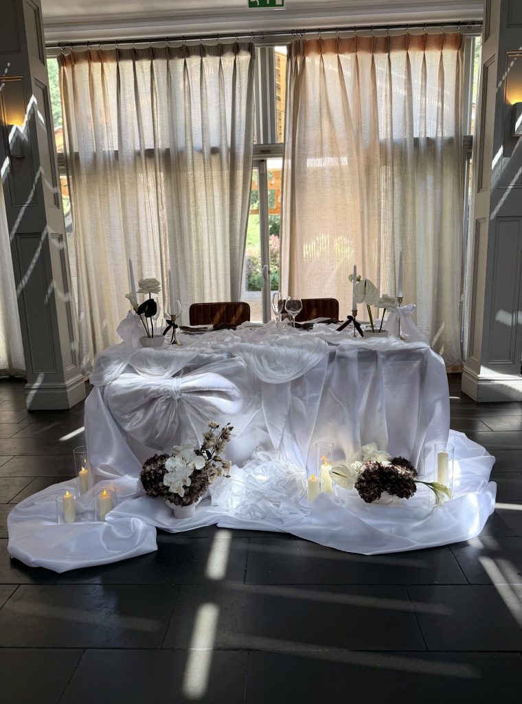 sweetheart table fabric draping and flowers Hampton manor