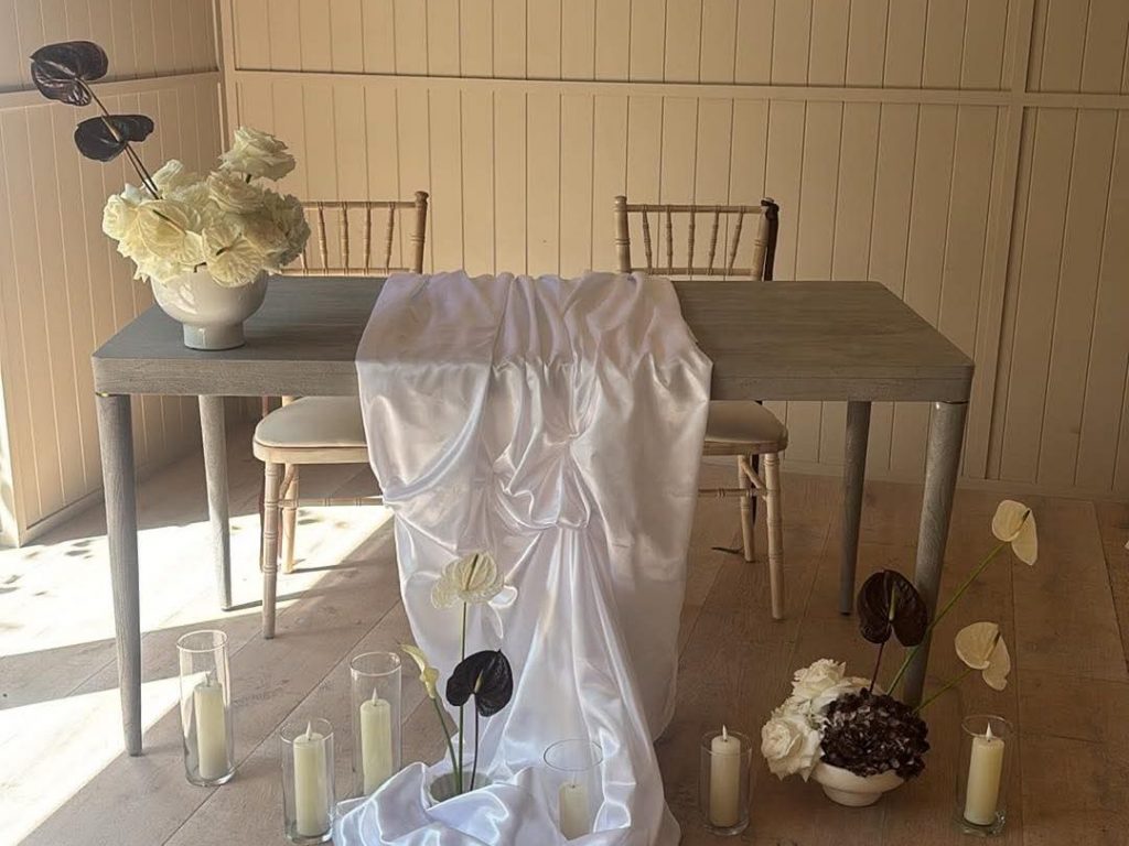 registra table with draping and fresh flowers