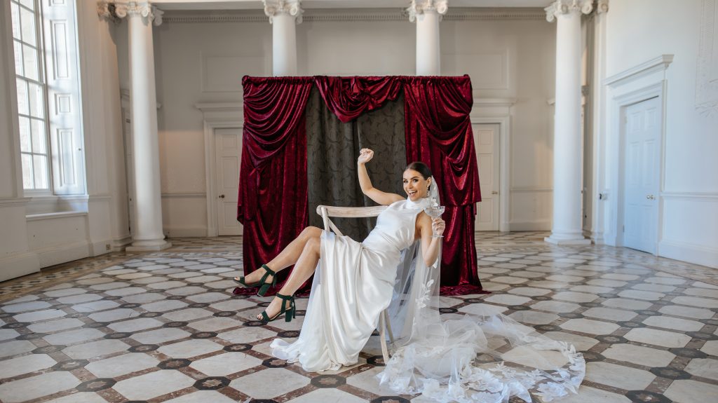 bride infront of bespoke fabric backdrop