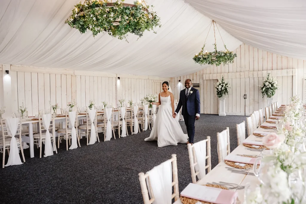 bride and groom in reception room fresh flowers and styling