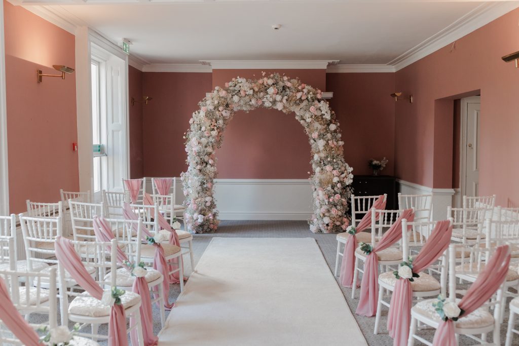 pastel arch ceremony room aisle
